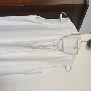 Sleeveless top with pearls around neck and flower details down front and neck